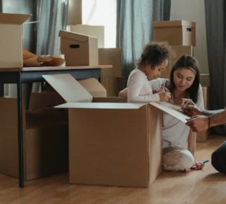 Family packing boxes to move home