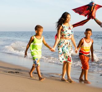 Family walking down the beach in Los Angeles