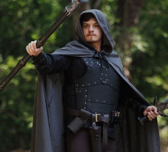 Cloaked fantasy warrior with staff and sword