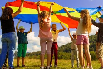 a group of children play a flag game outdoors