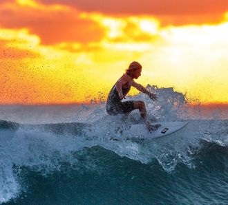Surfing at sunrise