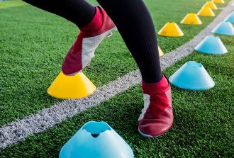 Close up of feet working in training soccer cones