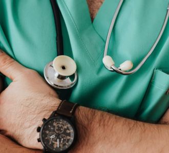 Male nurse with arms crossed