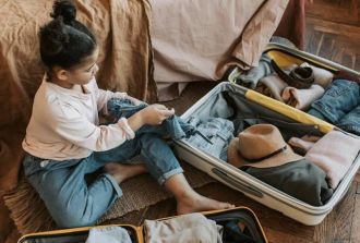 Young girl packs bags