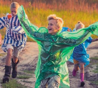 a bunch of kids run and play in the rain