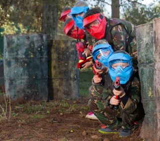 Kids of all ages having fun playing paintball