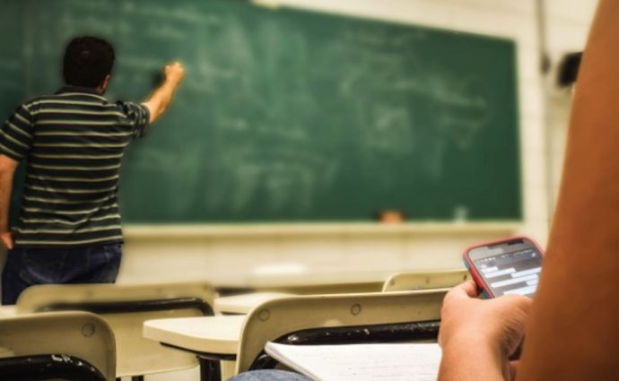 teacher at chalk board