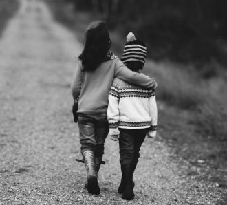 A sister with her arm around her brother