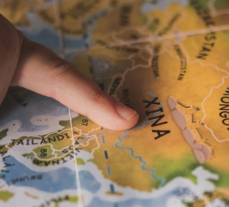 A kids finger on a map