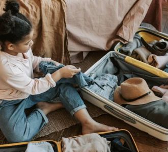 Young girl packs bags