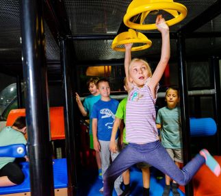 children playing on obstacle course