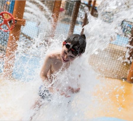 alton towers water park kid getting wet from the ride