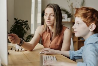 mum teaching son on computer