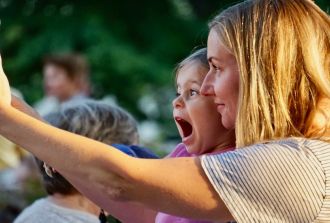 mum and daughter take selfie at concert