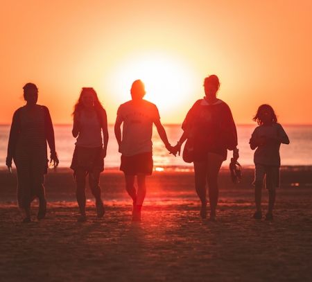 family at sunset on beach