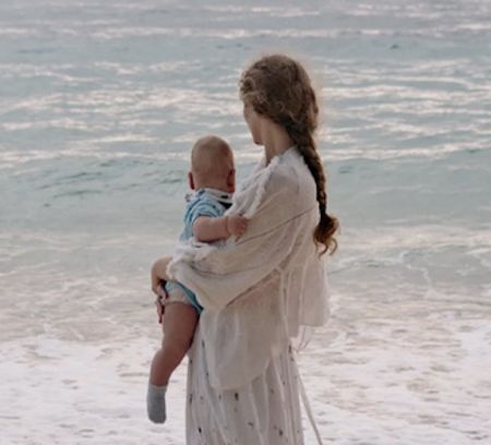 a young mother with her child on a beach