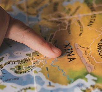 A kids finger on a map