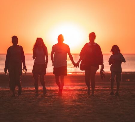 Family on beach at sunset