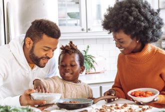 a young family enjoy cooking together