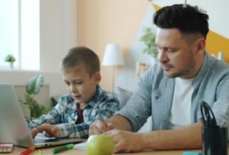 father and son leanring at computer