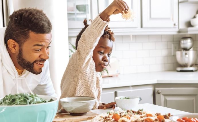 Family making homemade pizza together for National Pizza Day