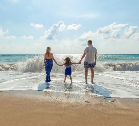Family on beach near water