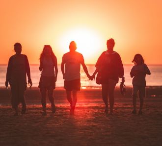 Family on beach at sunset