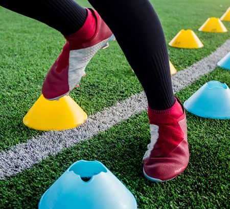 Close up of feet working in training soccer cones