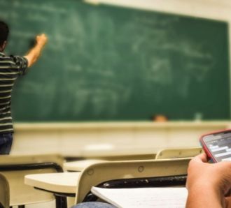 teacher at chalk board