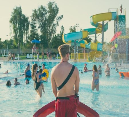 a lifeguard watches a waterpark