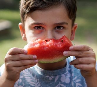 young boy eating watermelon family day out blog encouraging healthy eating in children
