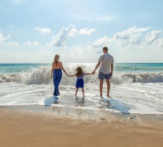 Family on beach near water