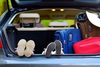 kids feet in car ready for road trip packed luggage