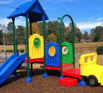 Colorful preschool playground with slide and truck