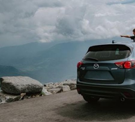 kid staring out of car into the landscape