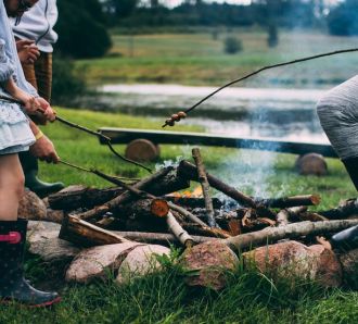 Family camping around camp fire