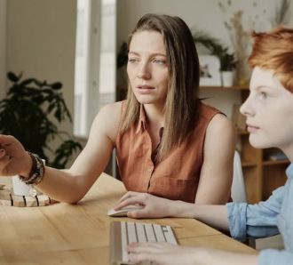 mum teaching son on computer