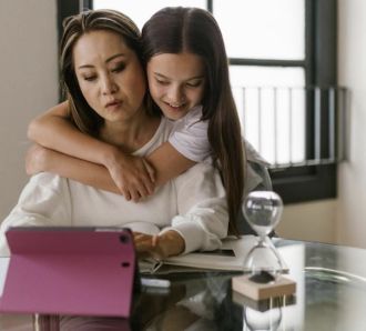 woman with girl on laptop