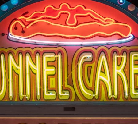 A close up of a funnel cakes sign