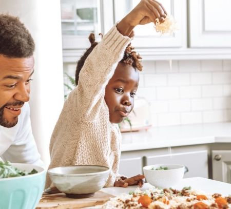 Family making homemade pizza together for National Pizza Day