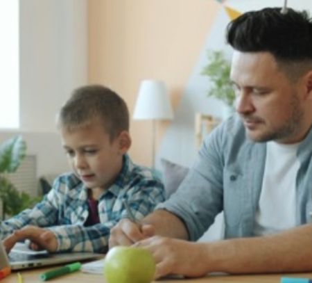 father and son leanring at computer