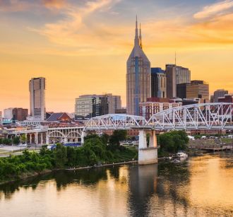 nashville, tennessee, nashville skyline across the river at sunset with bridge