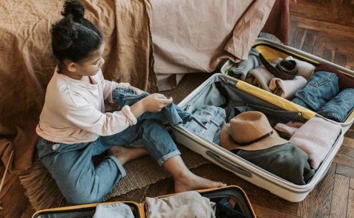 Young girl packs bags