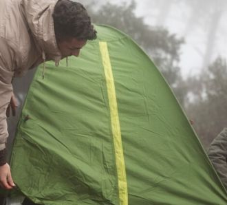 2 people putting up a tent together