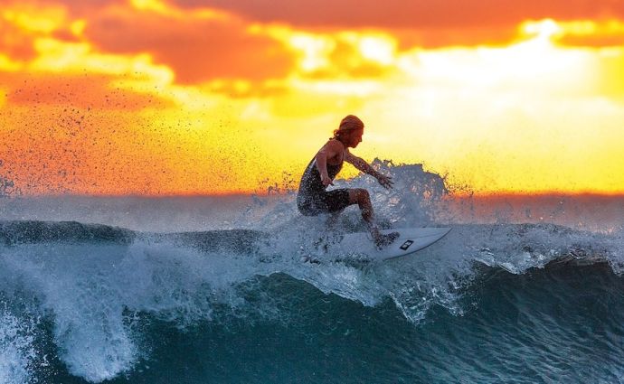 Surfing at sunrise