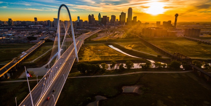 Texas skyline cityscape high above skyscrapers and suspension bridge over trinity river park